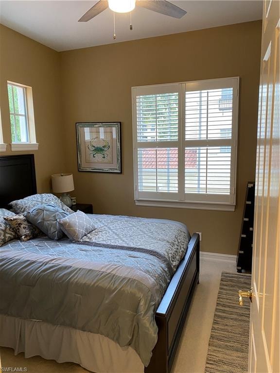 Bedroom with light carpet and ceiling fan