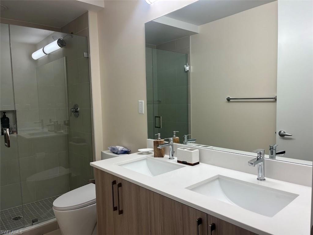 Bathroom with a stall shower and double vanity