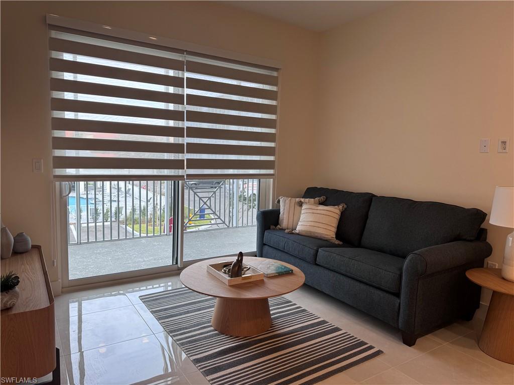 Living room with light tile patterned flooring