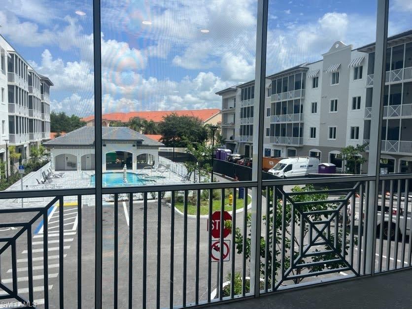 Balcony with view of pool and a sunroom