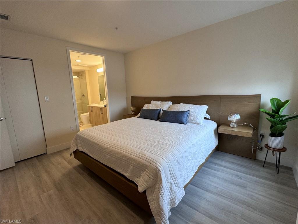 Bedroom featuring wood-type flooring and ensuite bathroom