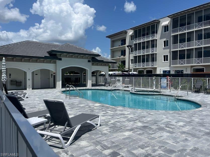 Community pool featuring a patio area and a community hot tub
