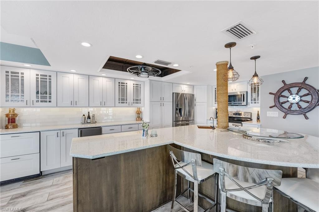 Beautiful glass cabinets, drink refrigerator and stand alone ice maker.