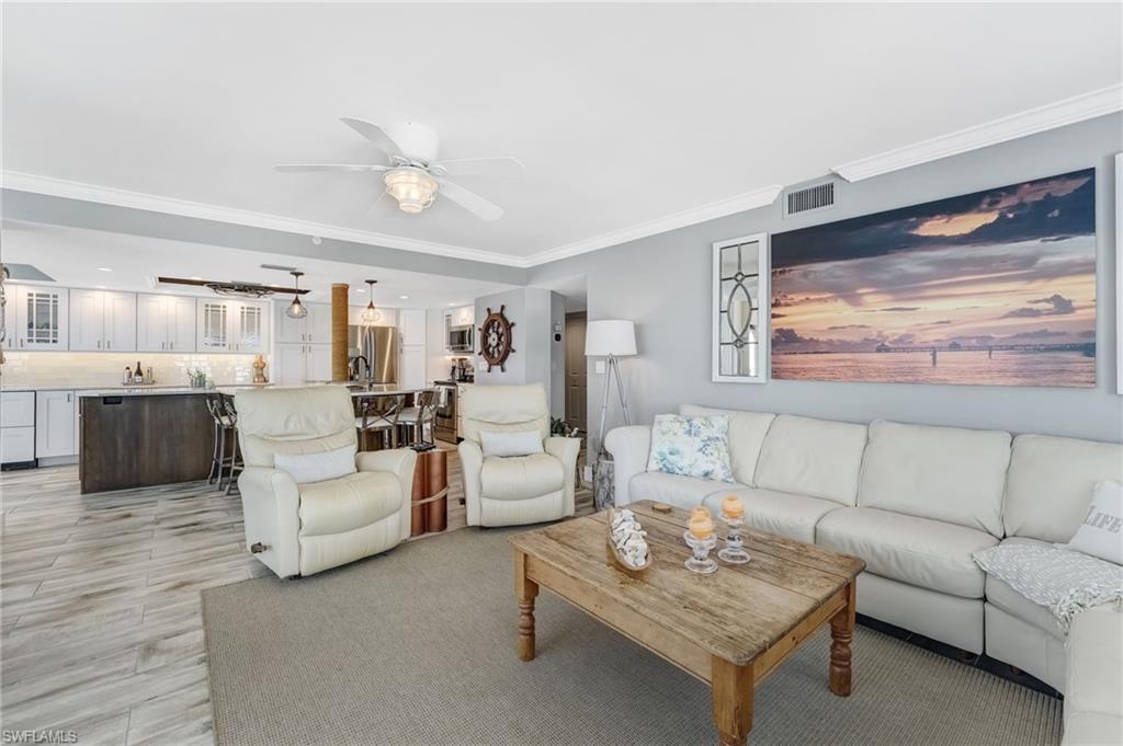 Open concept living room opens into the kitchen Island and the Lanai