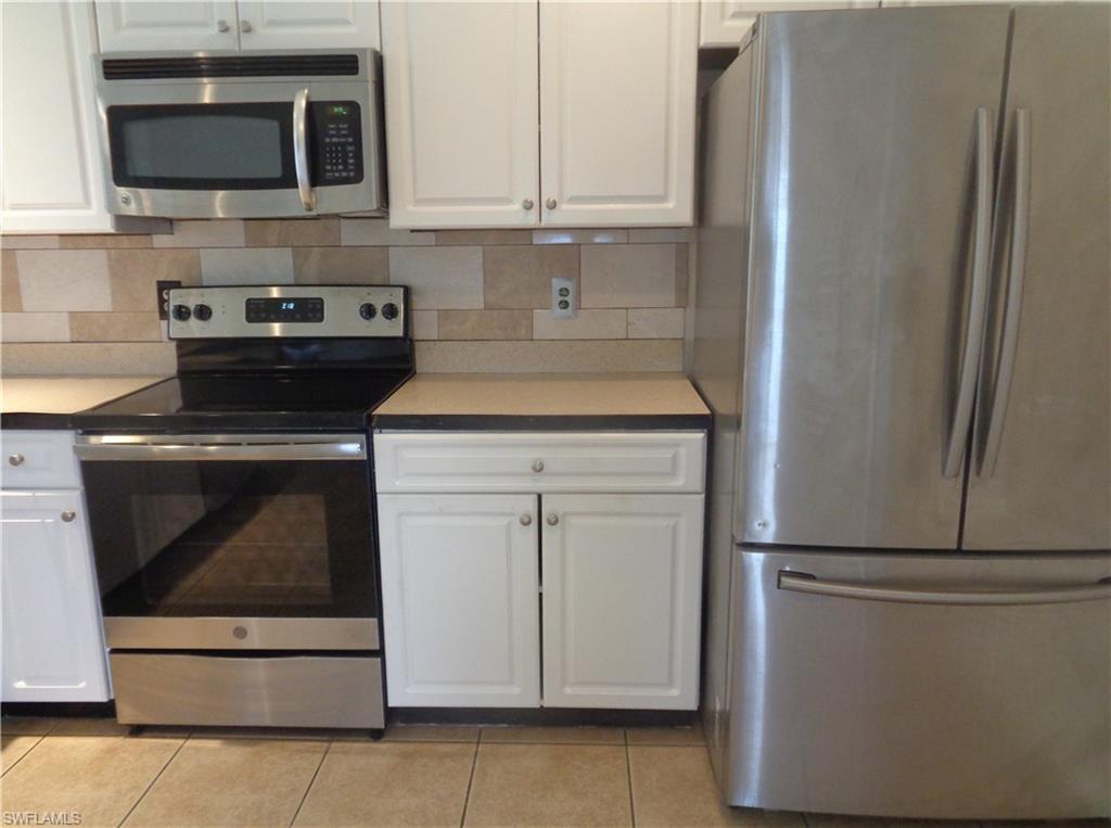 Stainless steel appliances: microwave, stove/oven and side by side door refrigerator