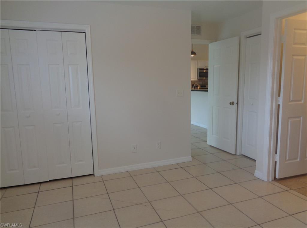 Master bedroom featuring light color tile floors and double closets