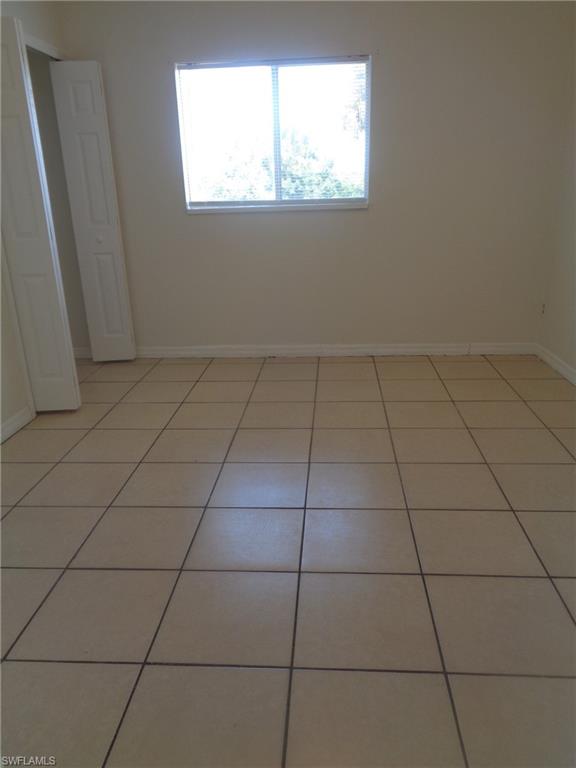 Guest bedroom 1 with closet and light patterned flooring