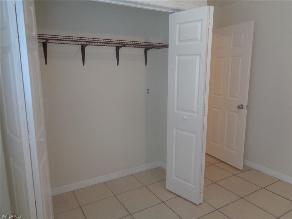 Guest bedroom 2 with closet and light patterned flooring