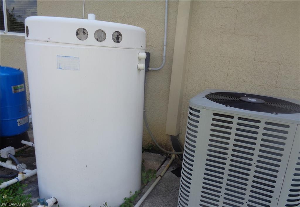 Exterior view featuring A/C compressor and water treatment equipment