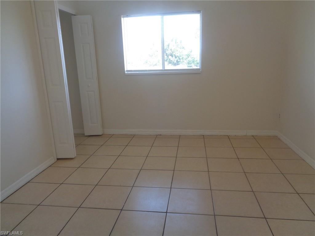 Guest bedroom 1 with closet and light patterned flooring