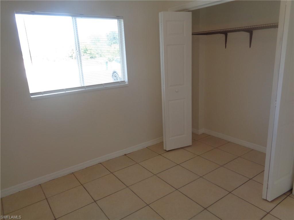 Guest bedroom 2 with closet and light patterned flooring