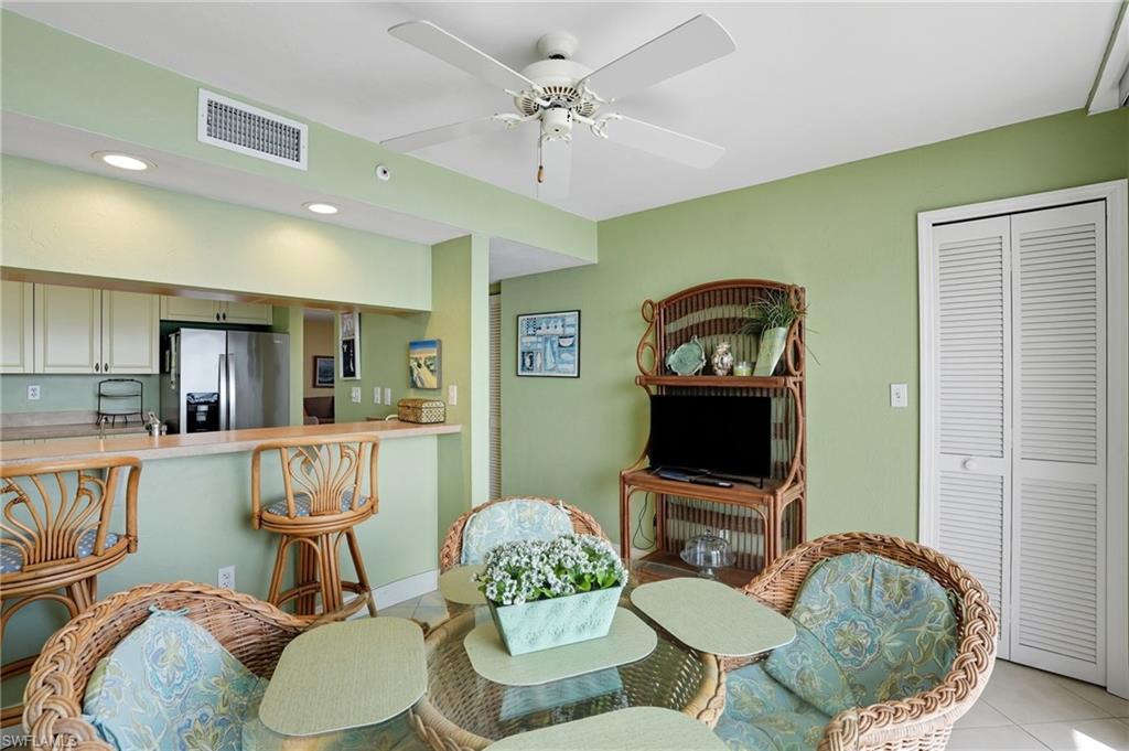 Dining room featuring light tile patterned flooring, recessed lighting, and a ceiling fan - Virtually Edited Image