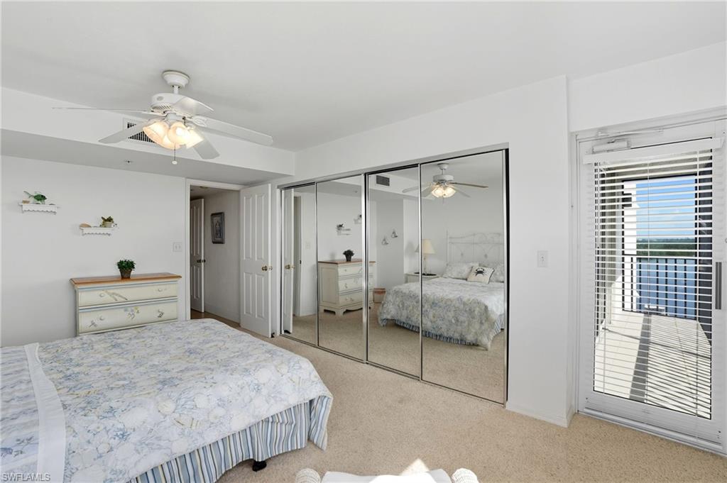 Carpeted bedroom featuring a ceiling fan and a closet - Virtually Edited Image