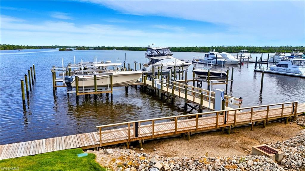 View of dock on bayside featuring a water view and boat lift - Virtually Edited Image
