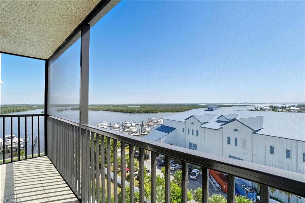 Kitchen Balcony with a water view, a sunroom, and view of marina - Virtually Edited Image