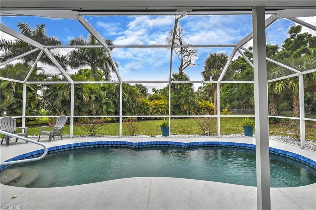 Swimming pool featuring a sunroom and a lanai