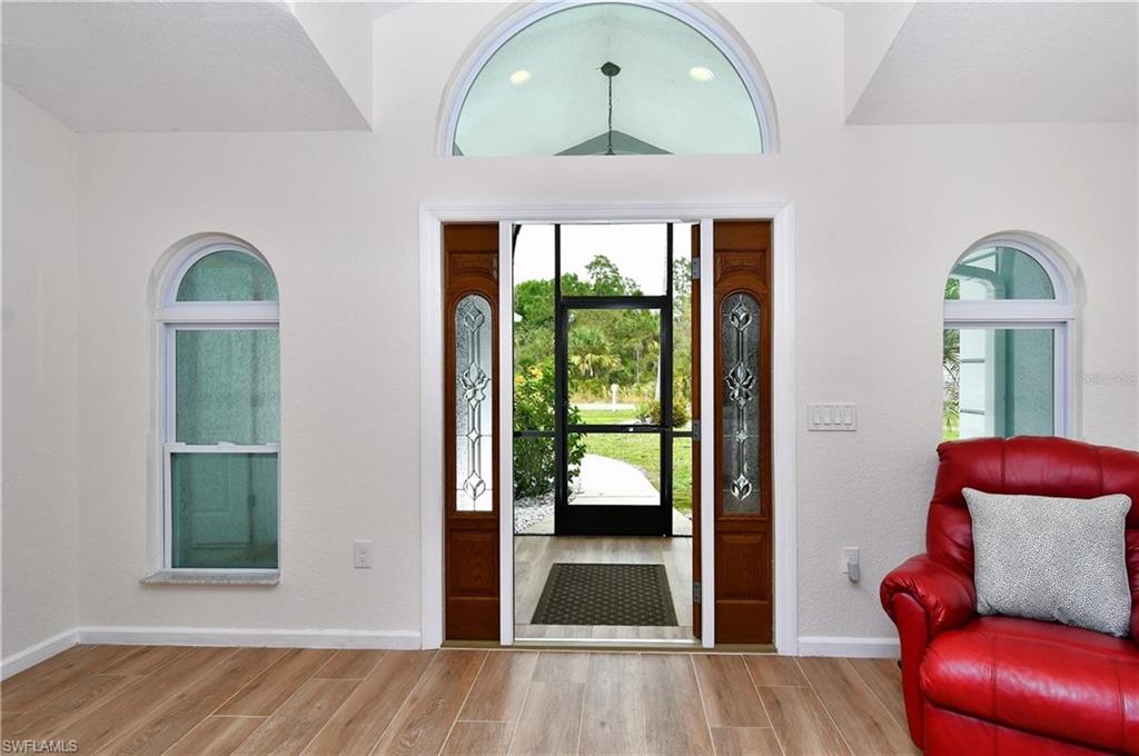 Foyer entrance featuring wood finish floors and baseboards