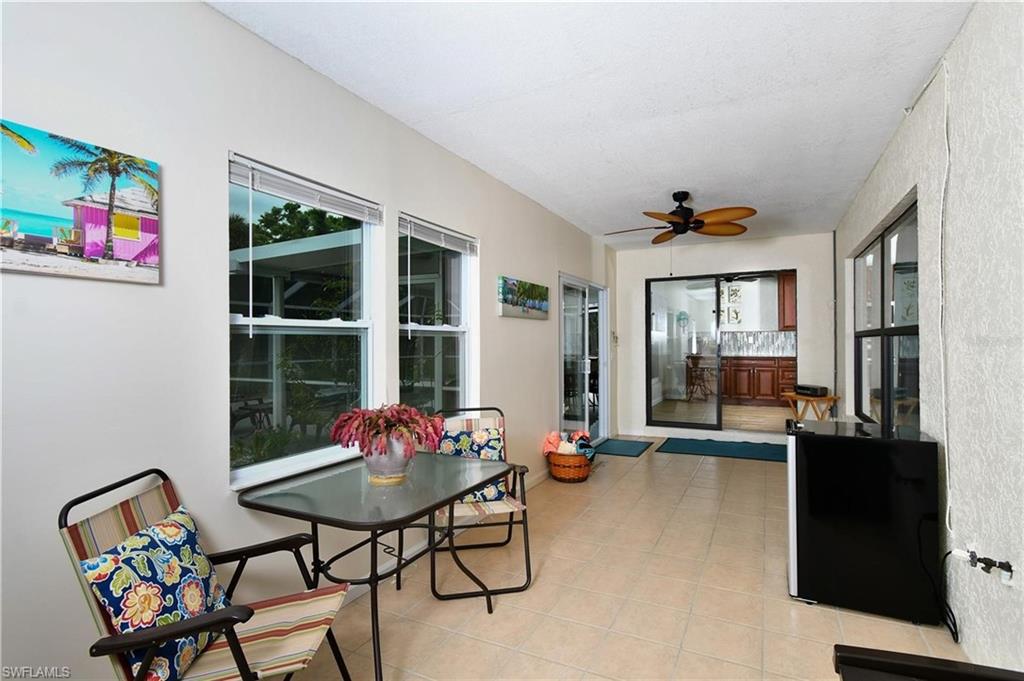 Sunroom / enclosed lanai featuring ceiling fan