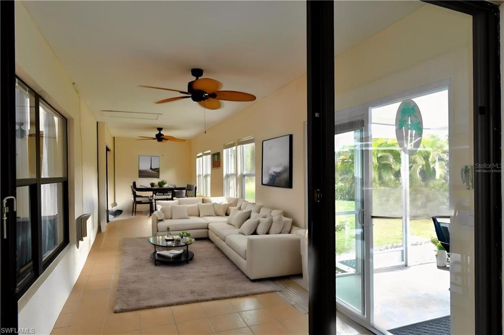 Enclosed Lanaifeaturing light tile patterned floors and a ceiling fan
