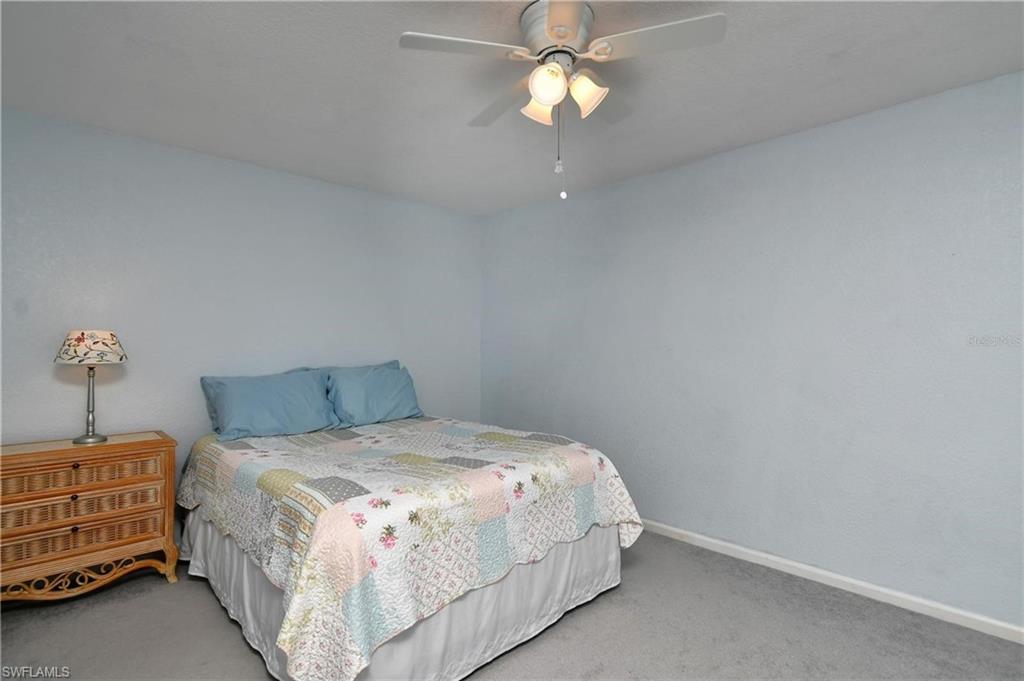 Bedroom featuring light colored carpet and ceiling fan