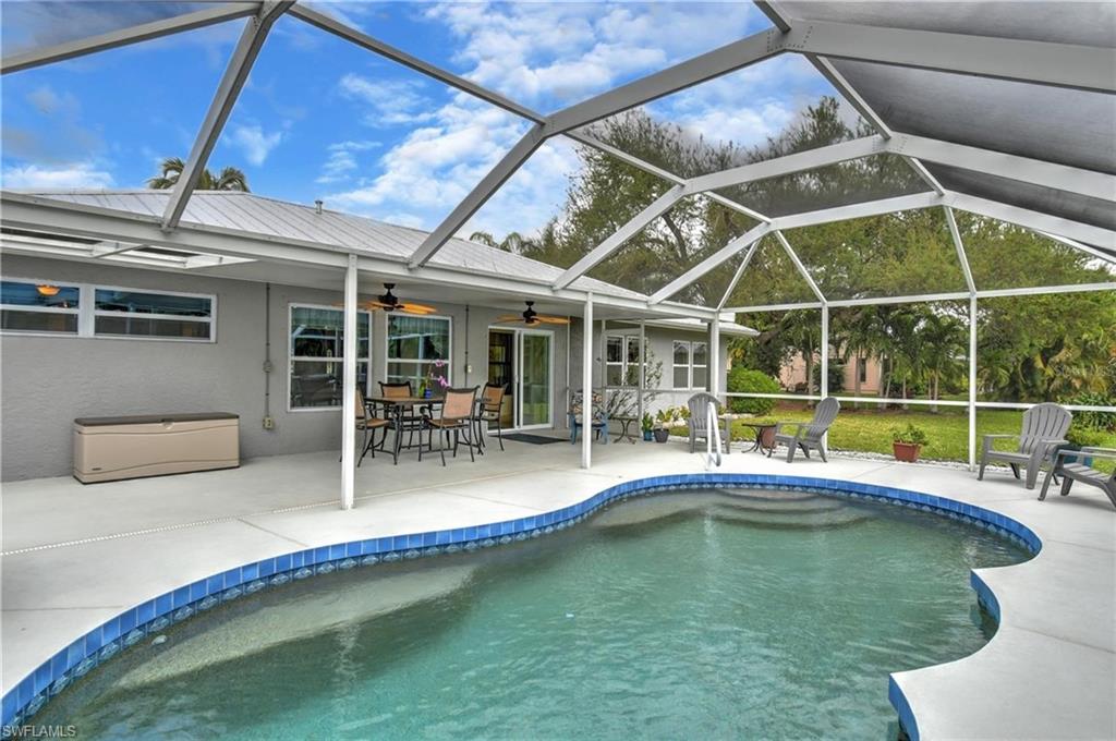 Swimming pool featuring a sunroom, a patio, a lanai, and outdoor dining space