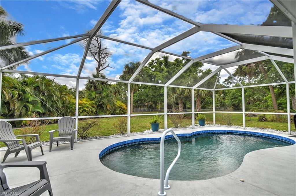Swimming pool featuring a lanai, a sunroom, and a patio