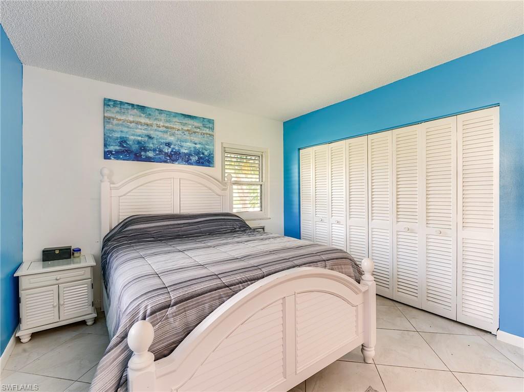Bedroom with a textured ceiling and a closet