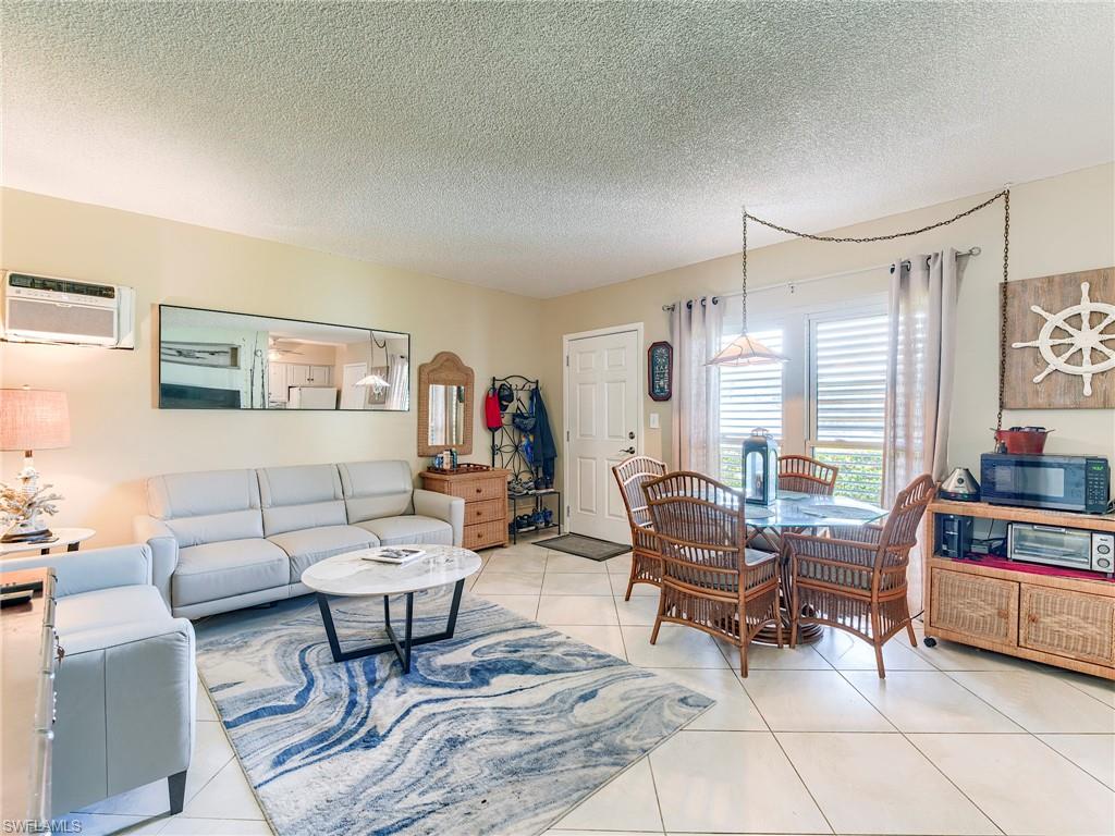 Living area featuring a textured ceiling and light tile patterned floors