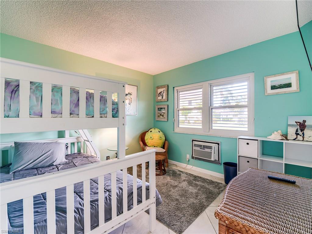 Bedroom featuring a textured ceiling and baseboards