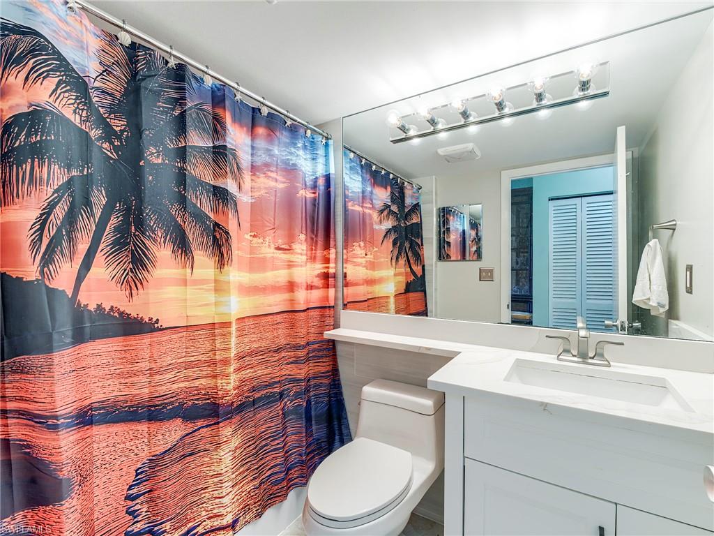 Bathroom with vanity and curtained shower