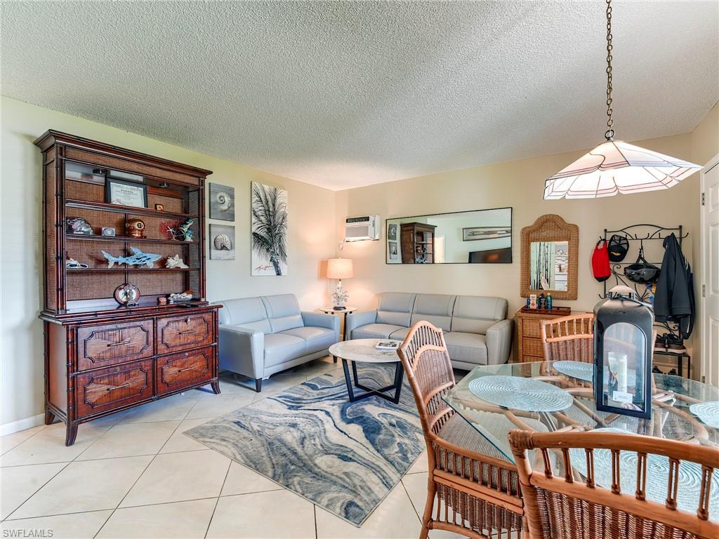 Living room featuring a textured ceiling and light tile patterned floors