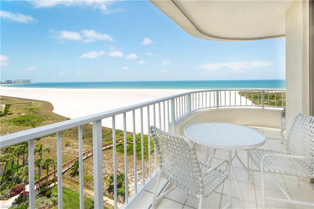 Balcony with view of water and beach