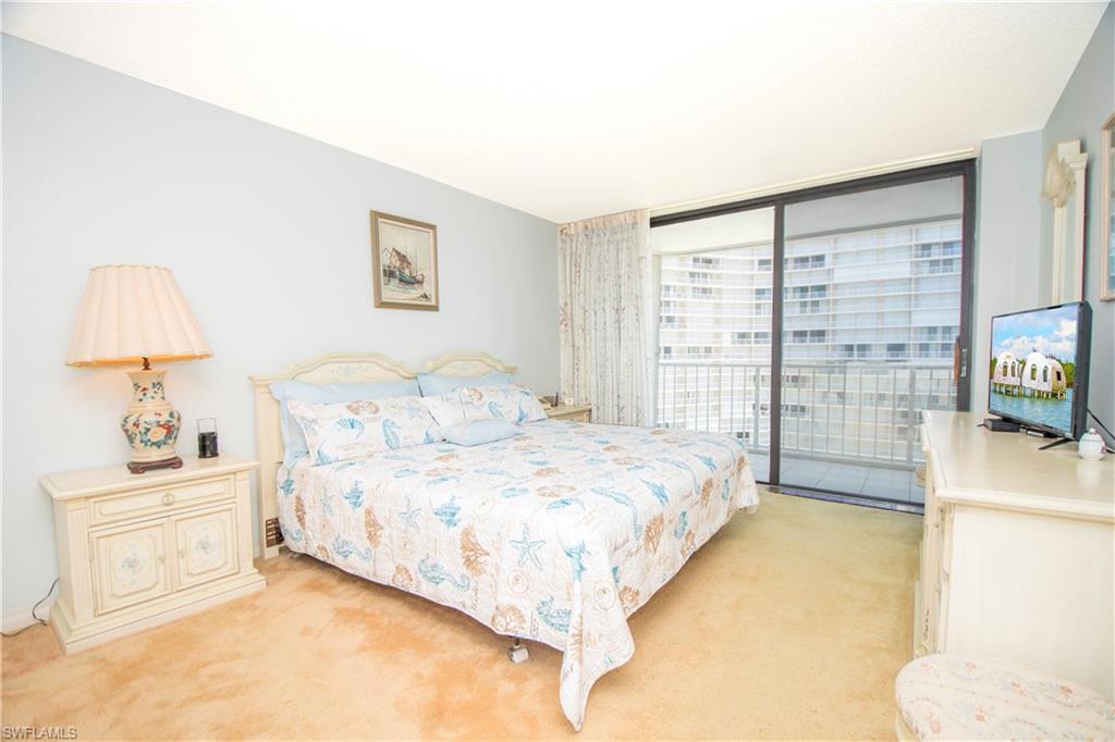 Bedroom featuring light colored carpet, access to outside, and floor to ceiling windows