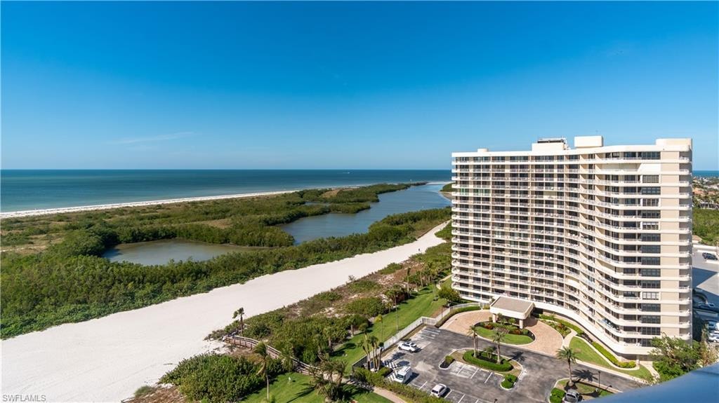The property offers expansive views of the ocean, a white sand beach, and natural waterways