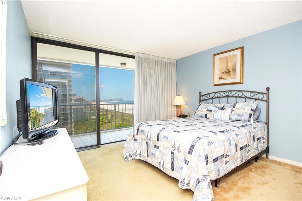 Carpeted bedroom featuring access to exterior and expansive windows