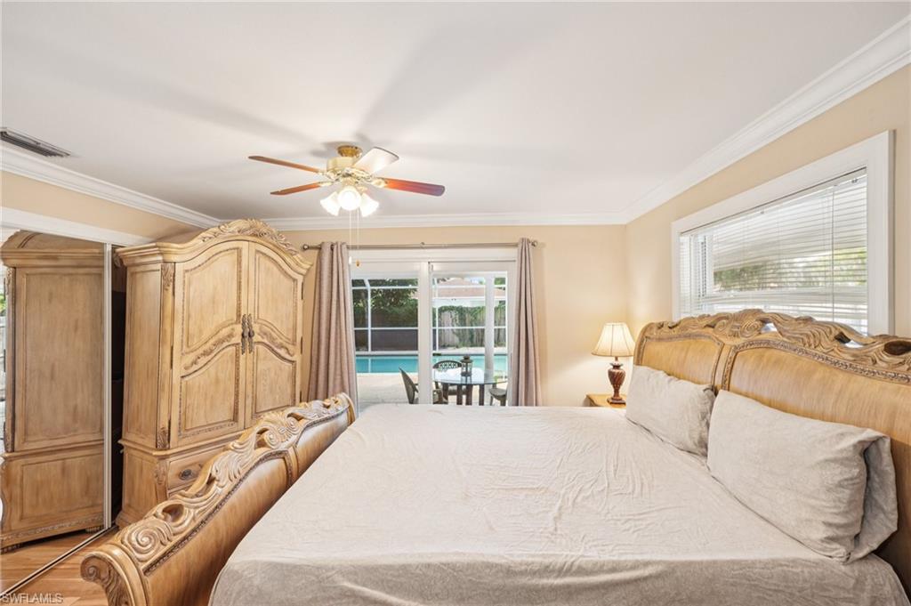 Bedroom featuring ornamental molding, access to exterior, ceiling fan, and light wood-style floors