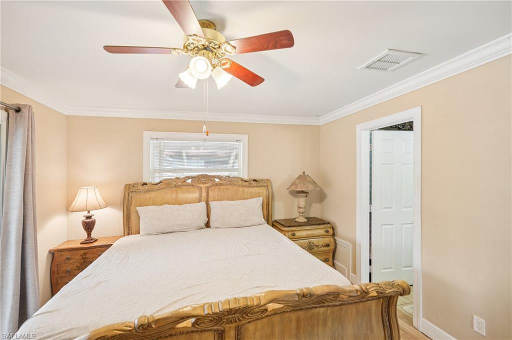 Bedroom featuring crown molding, a ceiling fan, and light wood-type flooring