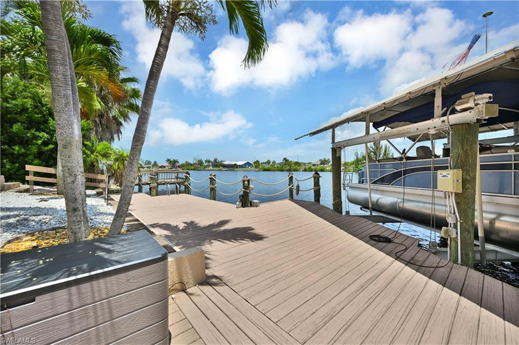 Waterfront property featuring a composite deck, boat lift, and dedicated dock space