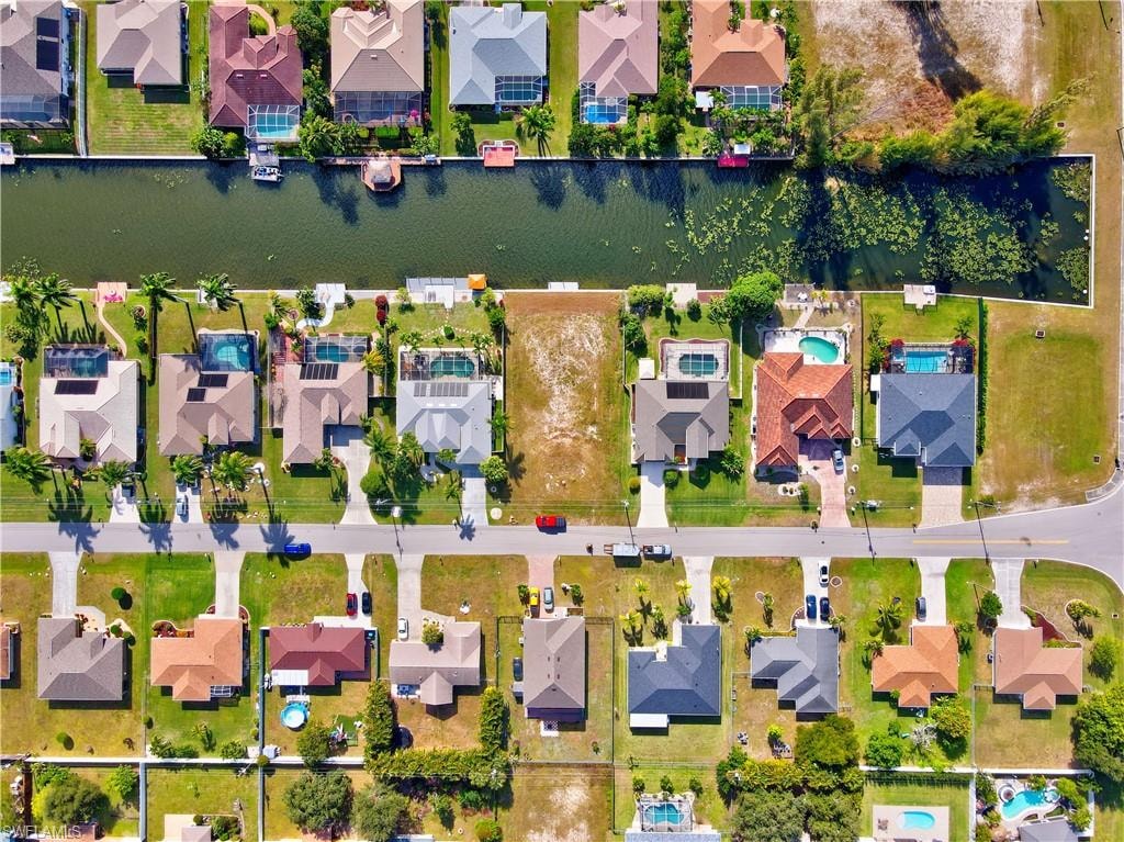 Aerial perspective of suburban area featuring a large body of water