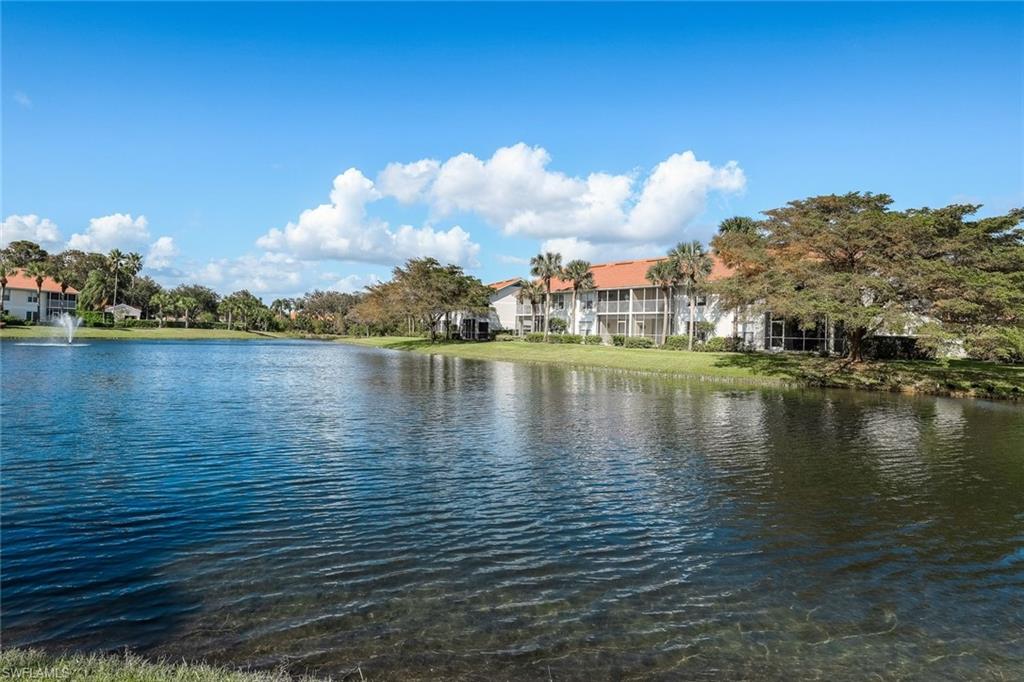 Serene lake view from the second-floor living area window in Carlton Lakes condo located in North Naples