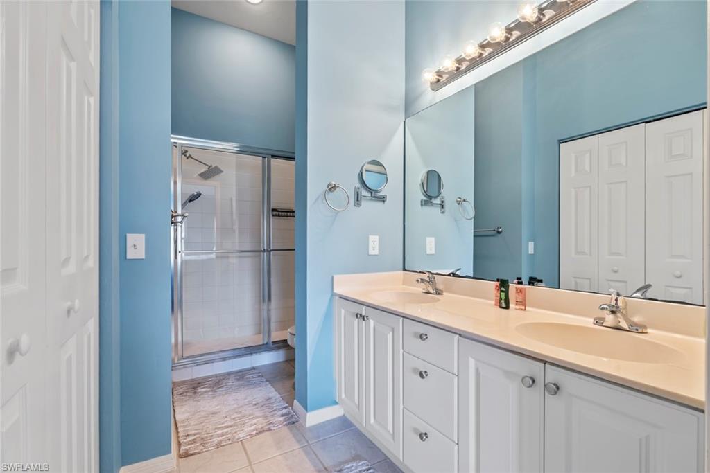 Full primary bathroom with dual sinks and walk-in shower.