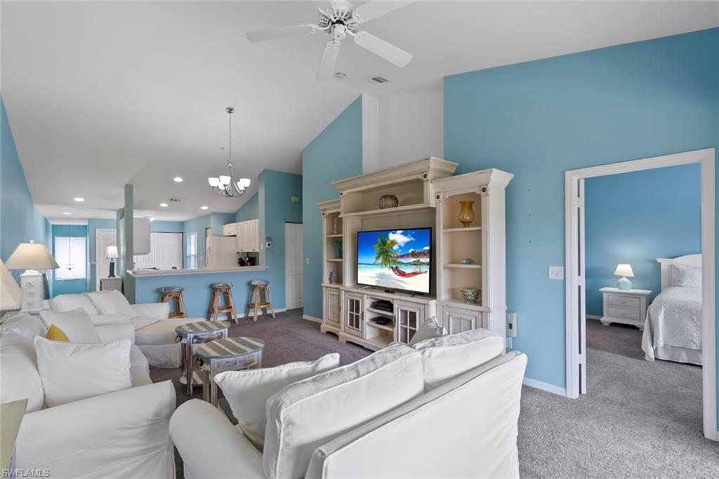 Bright, open-concept living room with abundant natural light and scenic lake view