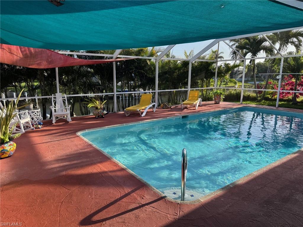 Relax in the shade under your blue and red sail and enjoy your heated pool that was resurfaced in 2026.