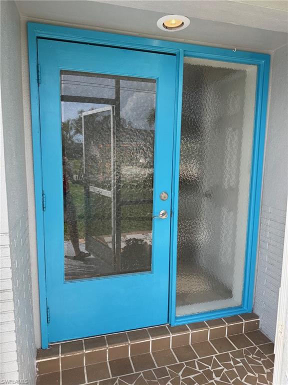 Beautiful glass front door with side light window. The front porch is tiled and screened in. Lots of natural light in this home.