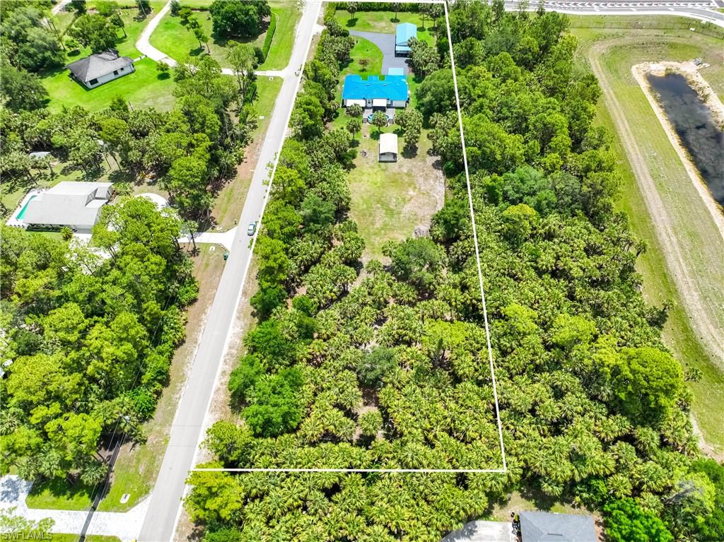 Aerial perspective illustrates the depth of the 2.81-acre lot with wooded privacy and open usable land.