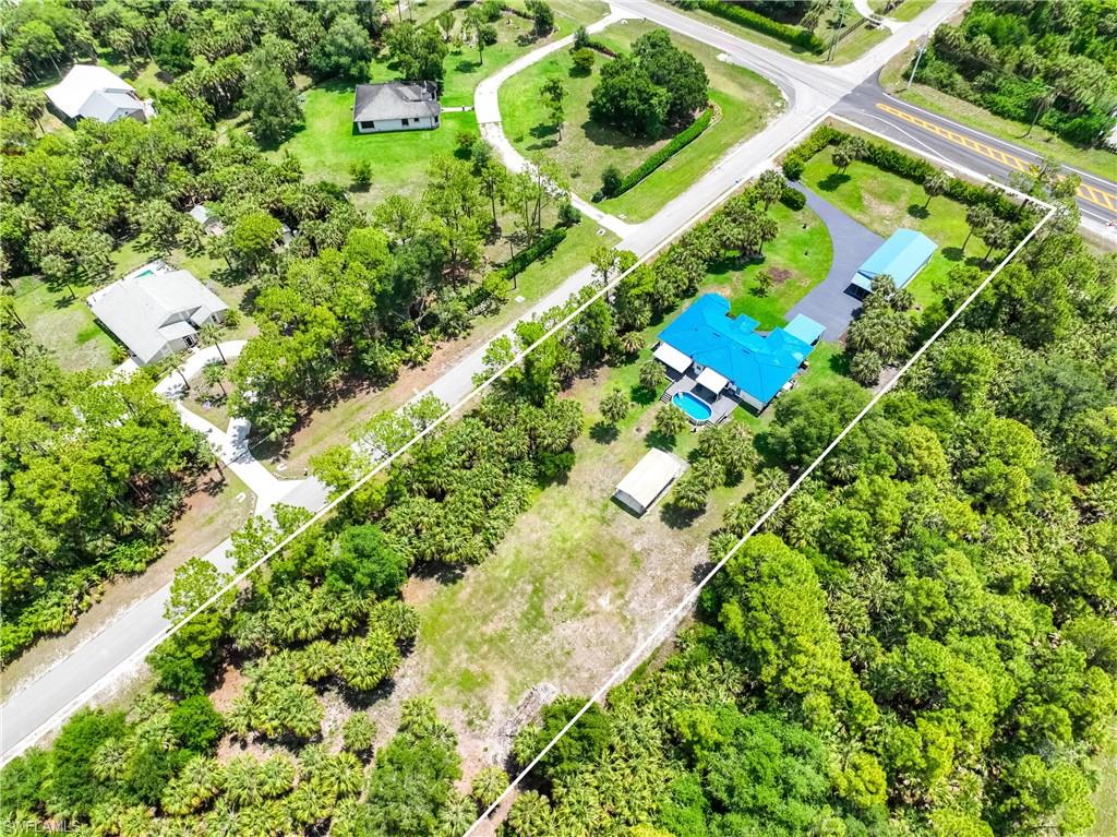 Elevated aerial view highlights the property's generous lot size and surrounding Golden Gate Estates landscape.