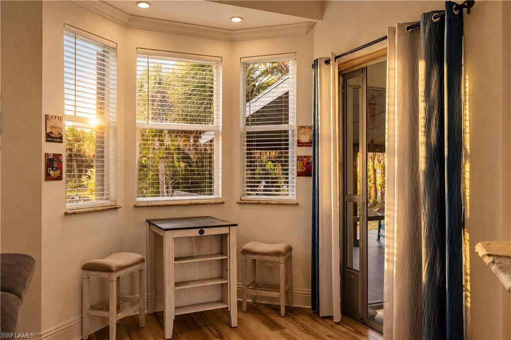 Primary suite sitting area offers peaceful backyard views and direct access to the outdoor living space.