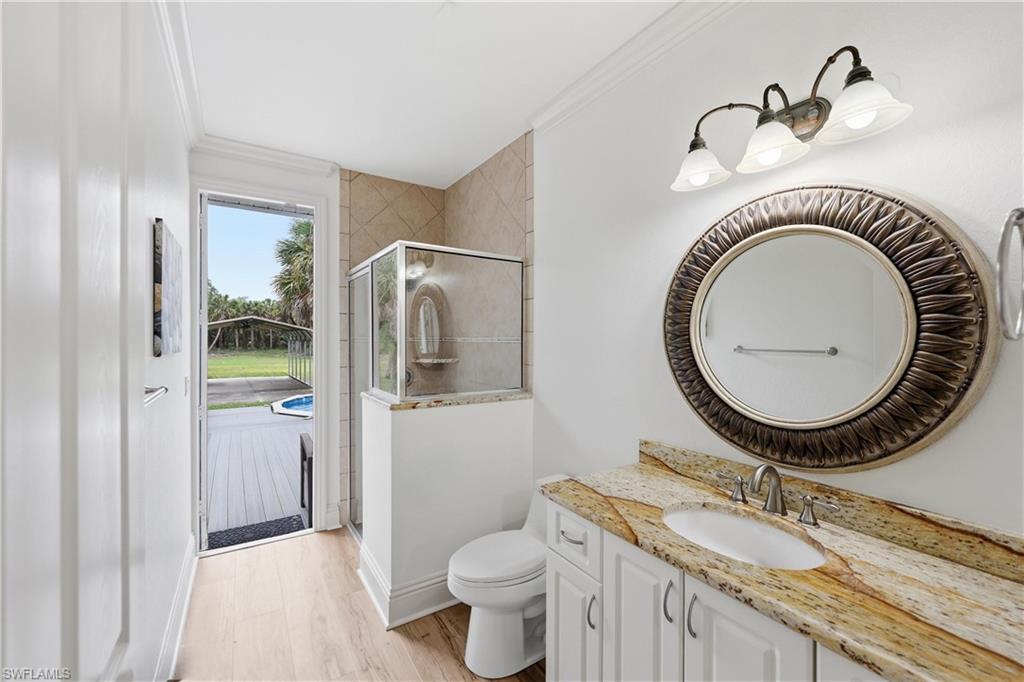Pool bath with granite vanity, walk-in shower, and direct access to the outdoor living area.