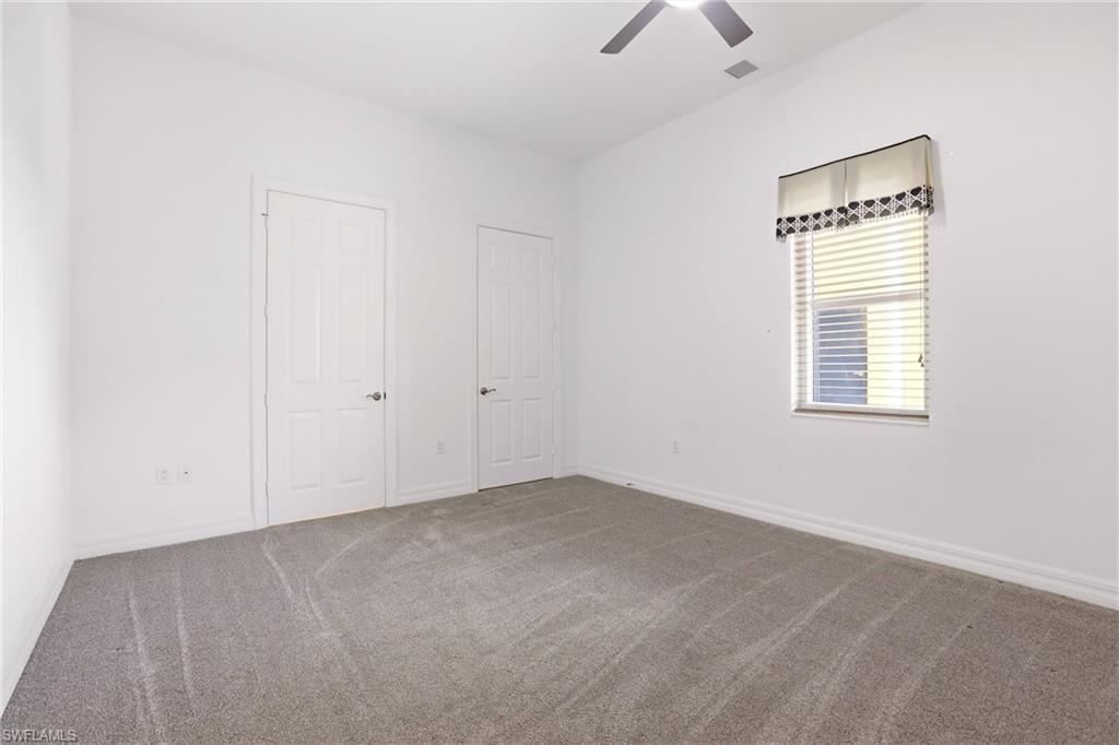 Unfurnished bedroom featuring carpet floors and ceiling fan