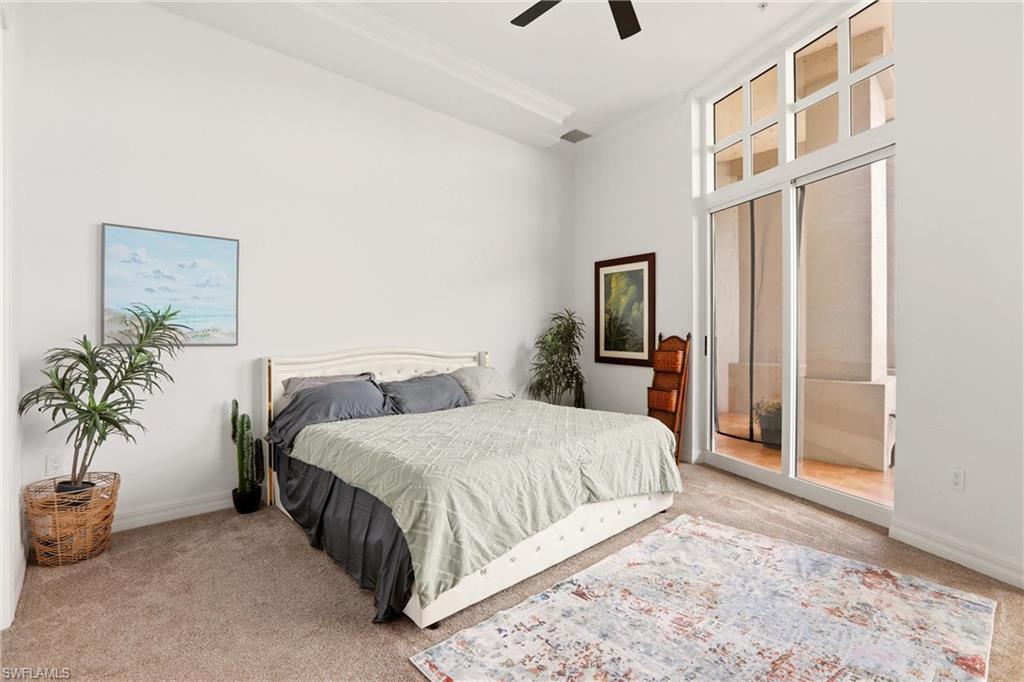 Bedroom featuring light colored carpet and a ceiling fan